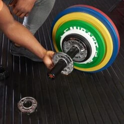 Mirafit Calibrated Cast Iron Weight Plates -Fitness Promotion Store Barbell Being Loaded with Full Set of Mirafit Calibrated Cast Iron Weight Plates