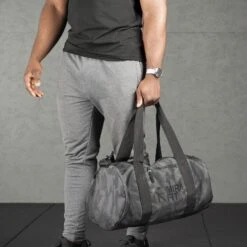 Mirafit Camo Gym Duffle Bag -Fitness Promotion Store Man Carrying a Mirafit Camo Gym Duffle Bag by the Handles