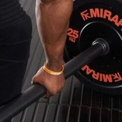 Mirafit Shorty 5ft Axle Bar -Fitness Promotion Store Man Gripping a Mirafit 5ft Black Axle Bar