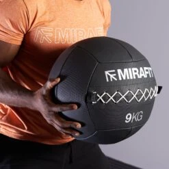 Mirafit Classic 13" Medicine Wall Ball -Fitness Promotion Store Man Holding Mirafit Gen 3 Stitched Medicine Wall Ball