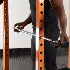 Mirafit Power Rack Spotter Bars -Fitness Promotion Store Man Inserting Mirafit Weightlifting Spotter Bar into Power Rack