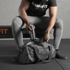Mirafit Camo Gym Duffle Bag -Fitness Promotion Store Man Loading a Mirafit Camo Gym Duffle Bag