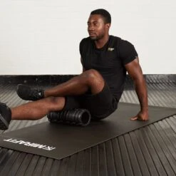 Mirafit Deluxe Hi-Density Foam Roller -Fitness Promotion Store Man Using Mirafit Black Deluxe Hi Density Foam Roller