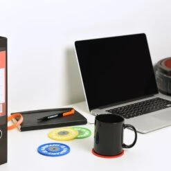 Mirafit Merchandise Bundle -Fitness Promotion Store Mirafit Drinks Coasters on White Desk with Mug on Top of Red Coaster