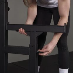 Mirafit M250 Adjustable Weight Bench & M230 Squat Rack Kit -Fitness Promotion Store adjusting the spotters on Black Mirafit Squat and Bench Press Rack 1