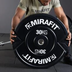 Mirafit XL 30kg Weight Plates -Fitness Promotion Store holding Mirafit XL 30kg Bumper Plates