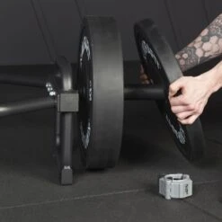 Mirafit Olympic Black Trap Bar With Stand -Fitness Promotion Store loading bumper plates onto mirafit olympic trap bar with stand