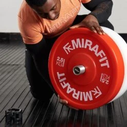 Mirafit Olympic Technique Bumper Plates -Fitness Promotion Store loading mirafit olympic technique bumper plates on technique bar