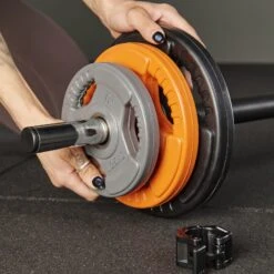 Mirafit 20kg Studio Pump Set - Black/Orange/Grey -Fitness Promotion Store loading plates on Mirafit 20kg Studio Pump Set