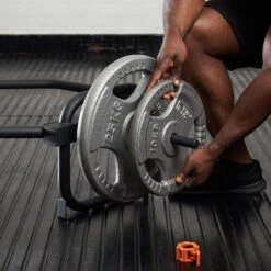 Mirafit Standard Black Trap Bar With Stand -Fitness Promotion Store loading plates onto black mirafit standard trap bar with stand