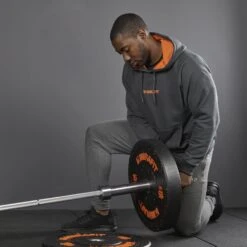 Mirafit Men's Charcoal Gym Hoodie -Fitness Promotion Store loading weight plates while wearing Mirafit Mens Charcoal Gym Hoodie 7