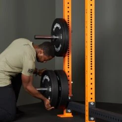 Mirafit M4 Chrome Weight Storage Poles -Fitness Promotion Store man installing Mirafit M4 Chrome Power Rack Olympic Plate Holders 2