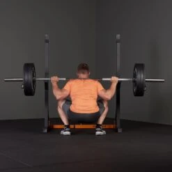 Mirafit Squat Rack With Barbell And Weights -Fitness Promotion Store man squatting with Mirafit M1 Squat Rack