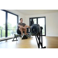 Concept2 Tall Legs RowErg Rower And PM5 Monitor -Fitness Promotion Store man using Concept2 RowERG High Legs
