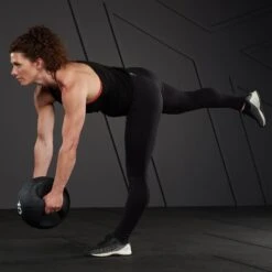 Mirafit Medicine Ball With Handles -Fitness Promotion Store woman doing single leg deadlift with Mirafit Double Handle Medicine Ball