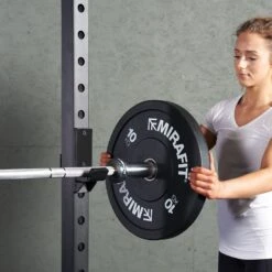 Mirafit M220 Squat Rack -Fitness Promotion Store woman loading a 10kg weight plate on a Mirafit M220 Squat Rack
