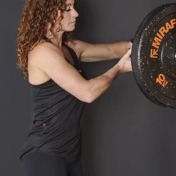 Mirafit Women's Loose-Fit Exercise Vest - Black 17 Mirafit Women's Loose-Fit Exercise Vest - Black -Fitness Promotion Store woman loading plates wearing Mirafit Womens Loose Fit Exercise Vest 8