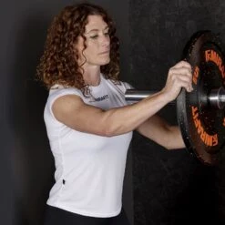 Mirafit Women's Technical Gym T-Shirt - White -Fitness Promotion Store woman loading weight plates wearing Mirafit Womens Technical Gym T Shirt 8