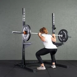 Mirafit M220 Squat Rack -Fitness Promotion Store woman performing squat on a black Mirafit M220 Power Rack